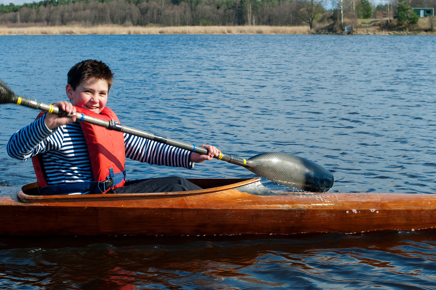 Dollarphotoclub_81755148_The-boy-rowing-in-a-kayak-on-the-river